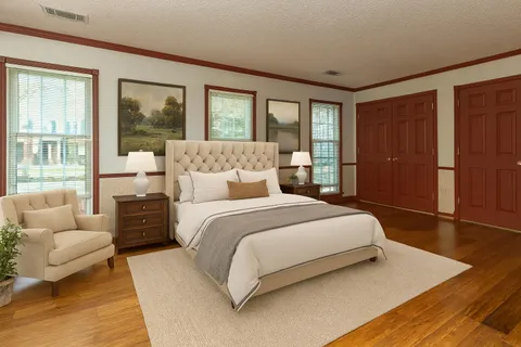 a bedroom with a large bed and a couch