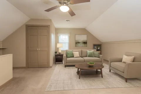 a living room with furniture and a chandelier