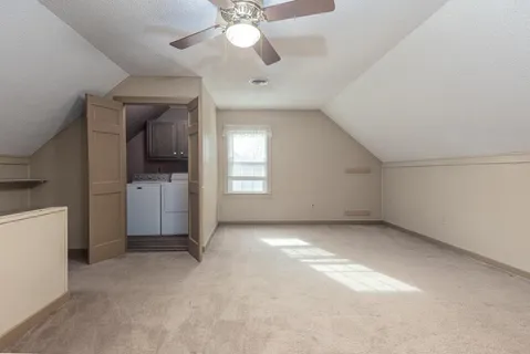 wooden floor in an empty room with a kitchen