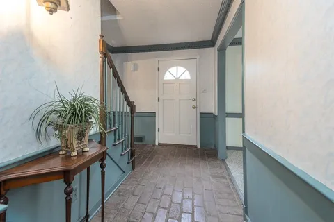 a view of hallway with wooden floor and stairs