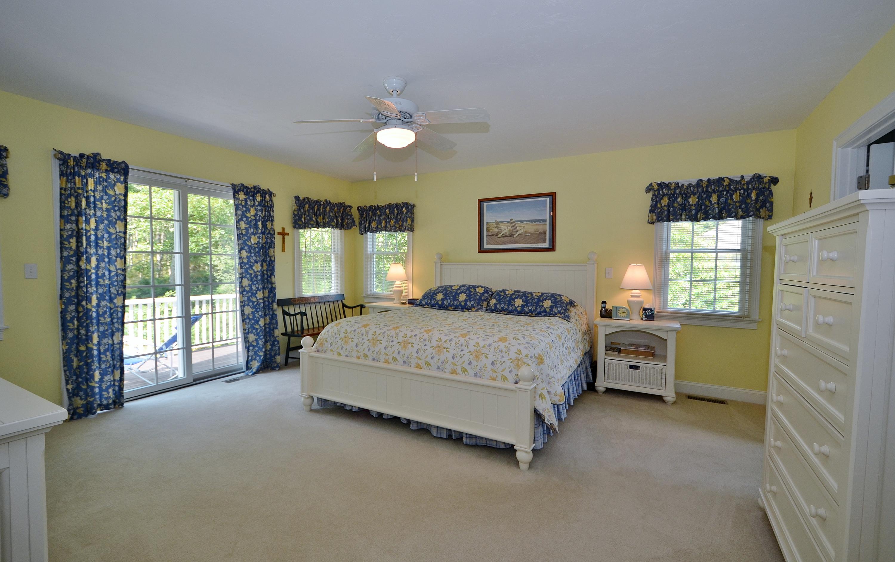 121 Cairn Ridge Road East Falmouth, MA 02536 - Photo 12 of 28 a spacious bedroom with a bed and a large window