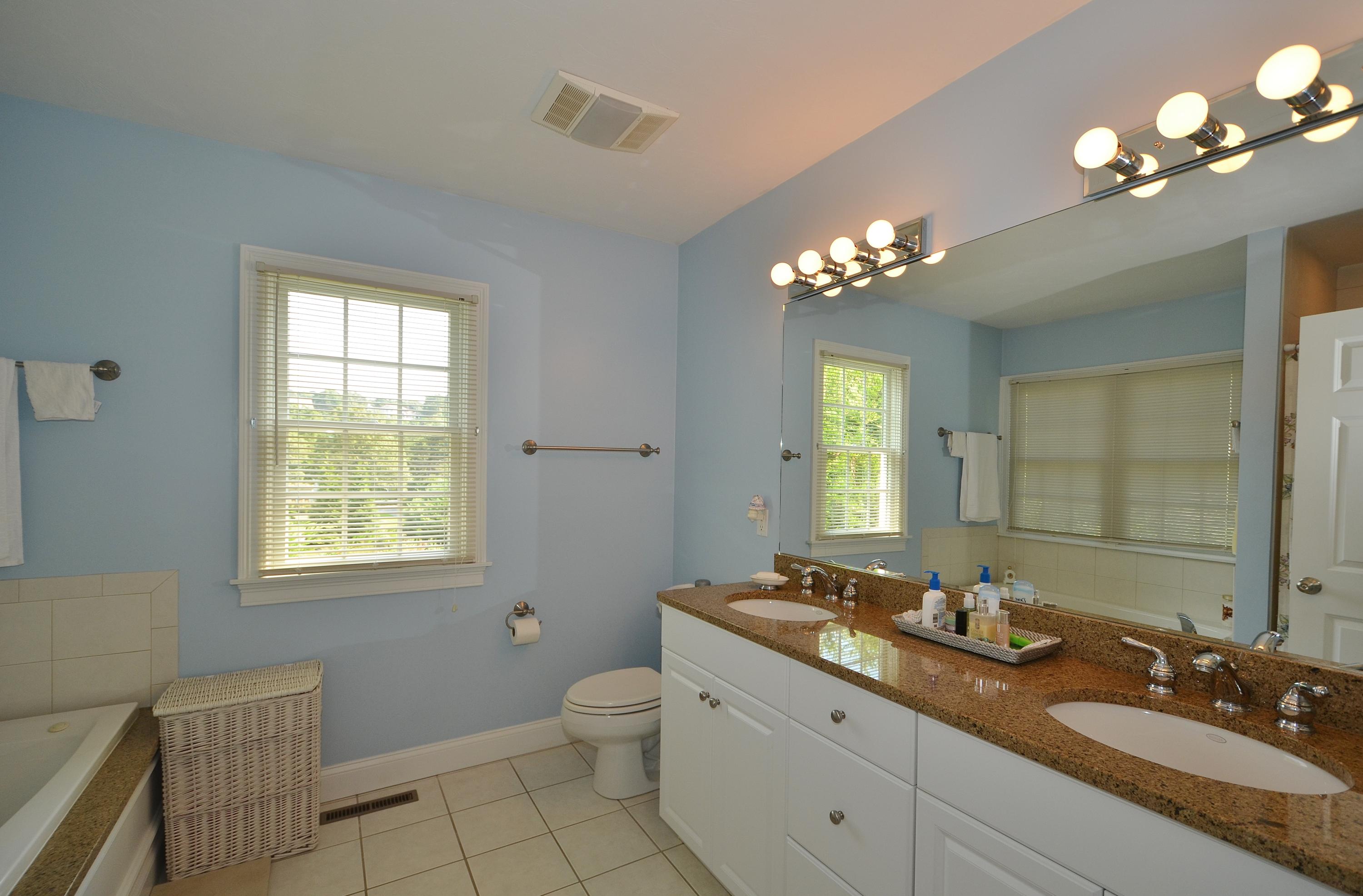 121 Cairn Ridge Road East Falmouth, MA 02536 - Photo 13 of 28 a bathroom with a toilet a sink a light fixture and a window