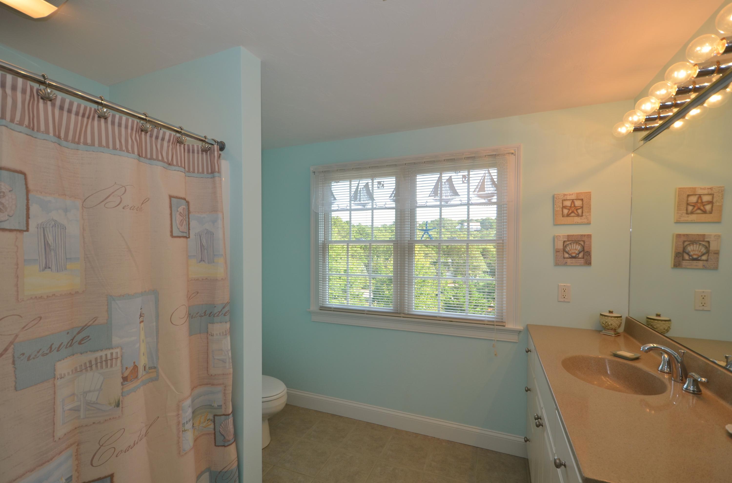 121 Cairn Ridge Road East Falmouth, MA 02536 - Photo 18 of 28 a bathroom with a granite countertop sink a toilet and shower