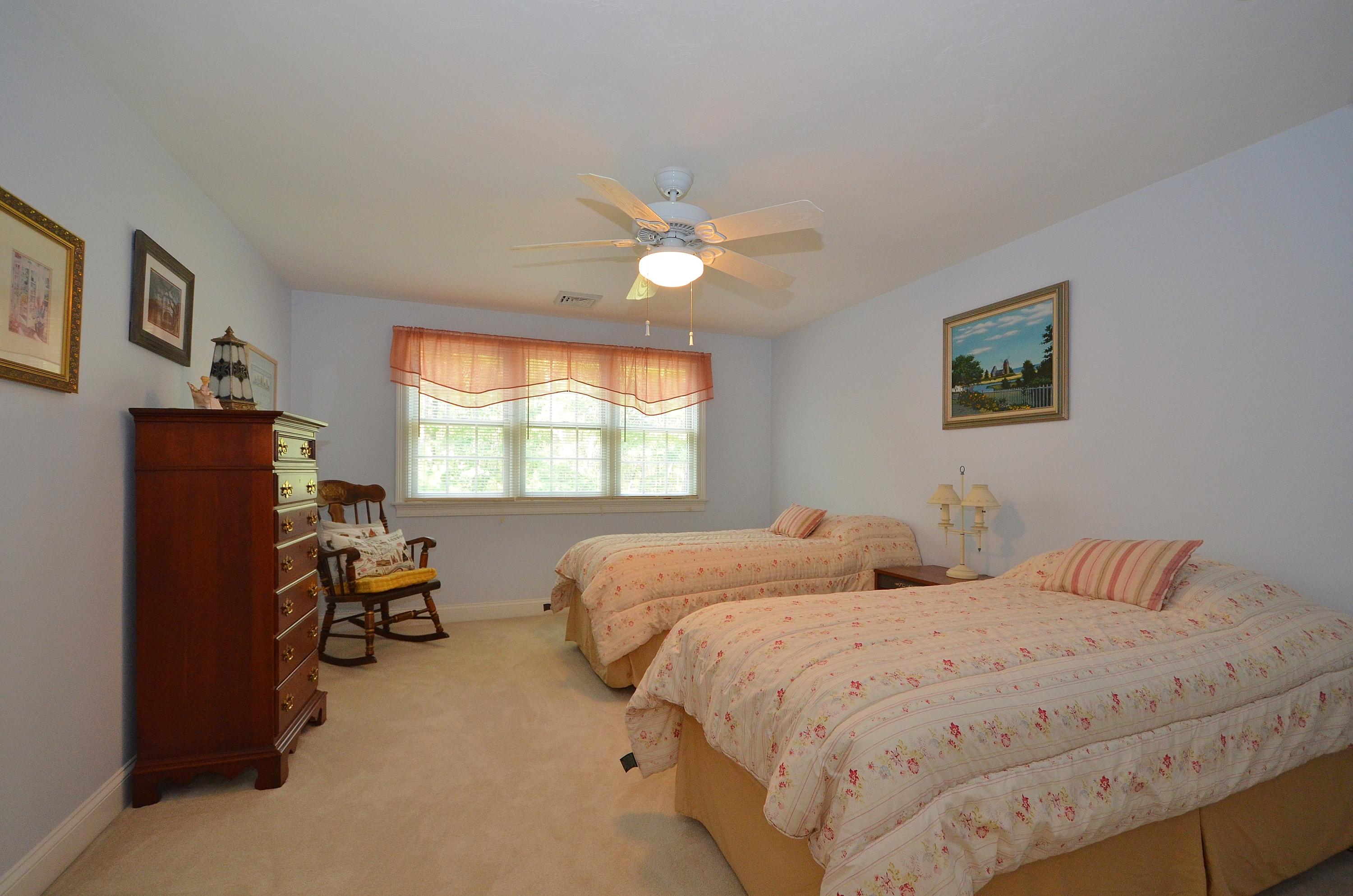 121 Cairn Ridge Road East Falmouth, MA 02536 - Photo 19 of 28 a bedroom with two beds and a chandelier