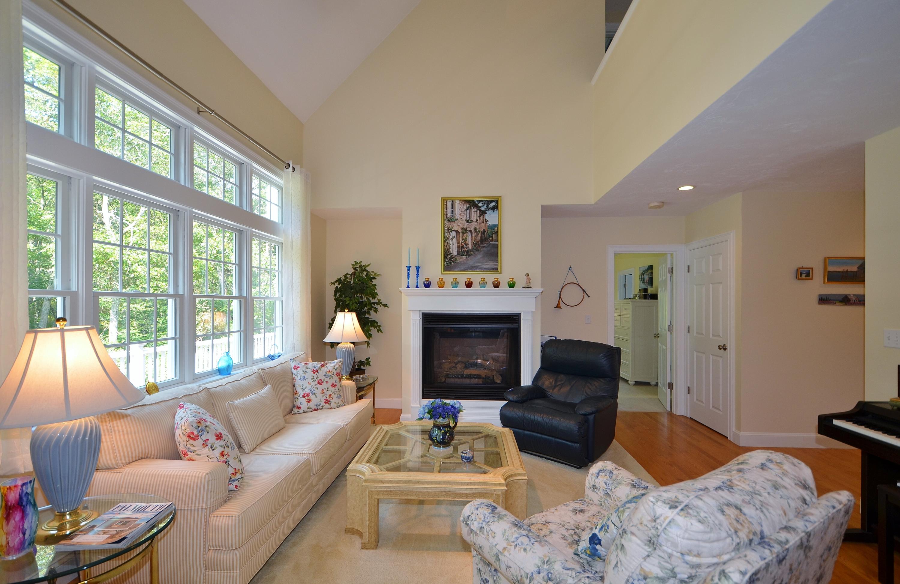121 Cairn Ridge Road East Falmouth, MA 02536 - Photo 3 of 28 a living room with furniture a fireplace and a large window