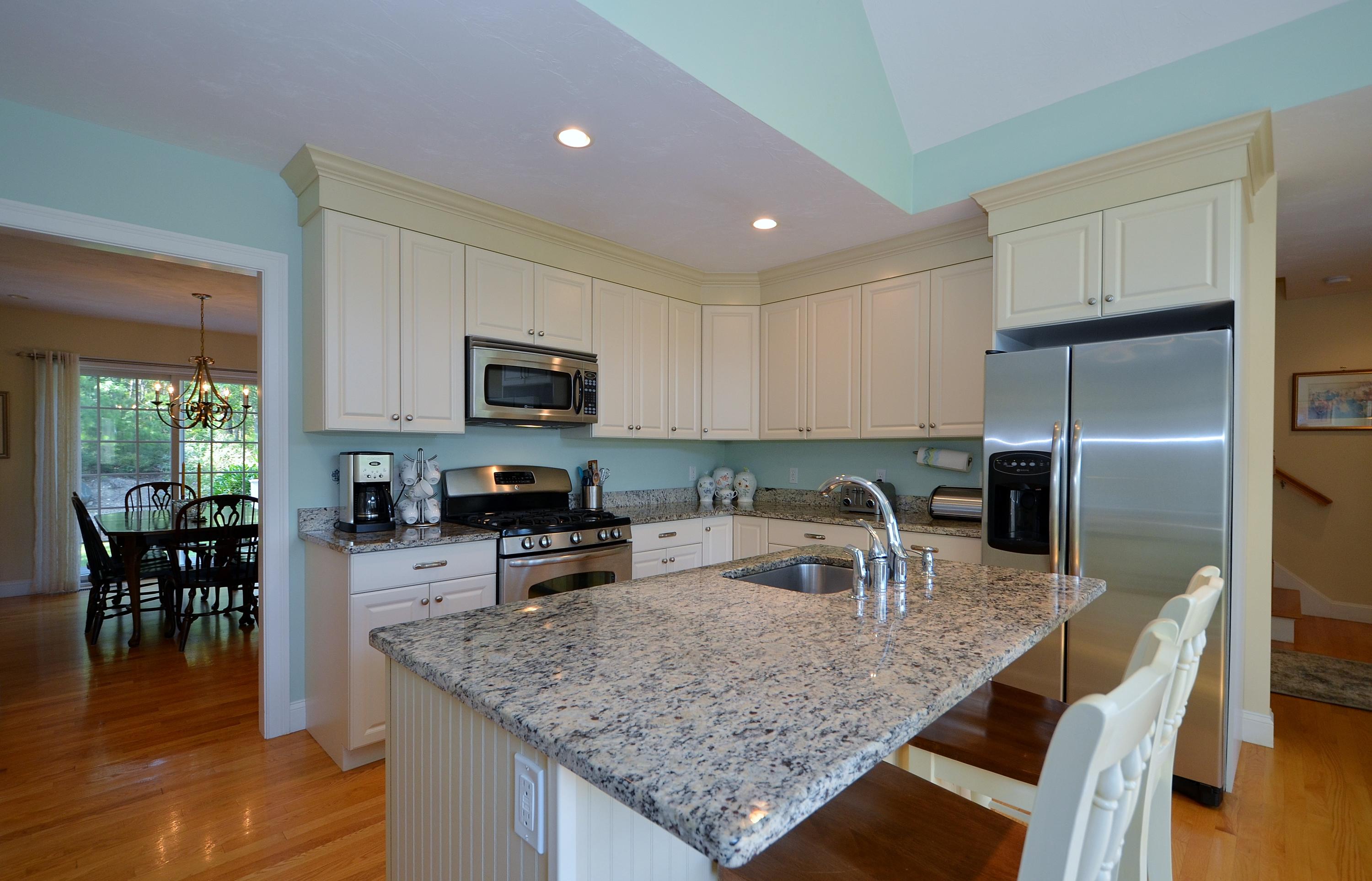 121 Cairn Ridge Road East Falmouth, MA 02536 - Photo 8 of 28 a kitchen with stainless steel appliances granite countertop a sink refrigerator and microwave