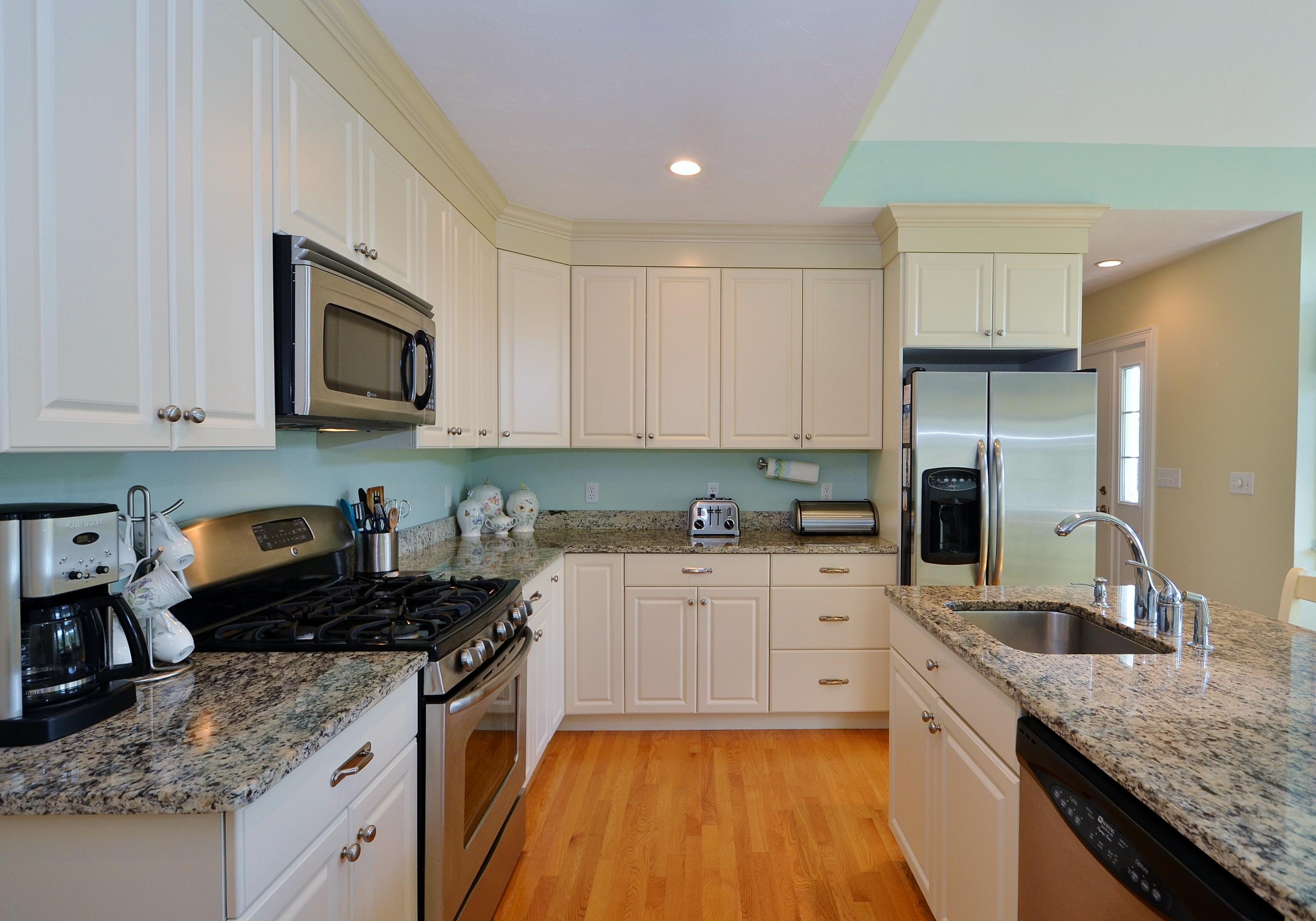 121 Cairn Ridge Road East Falmouth, MA 02536 - Photo 9 of 28 a kitchen with a sink stove top oven and refrigerator