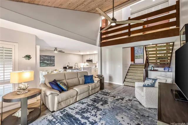 a living room with furniture and wooden floor