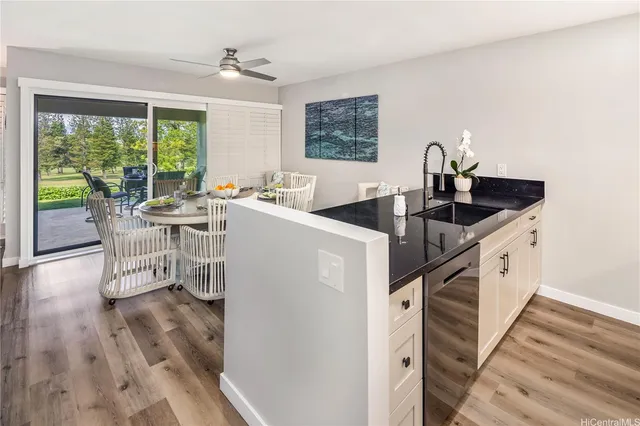 a kitchen with a sink and chairs
