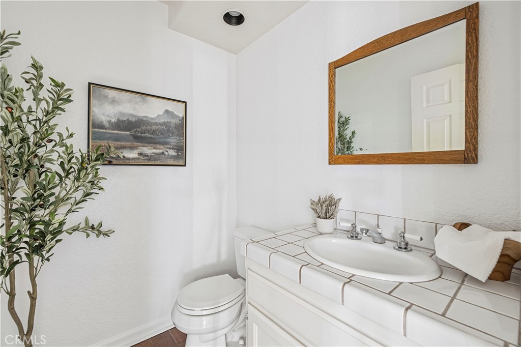 4131 Pelona Canyon Road Acton, CA 93510 - Photo 22 of 58 a bathroom with a toilet sink and mirror