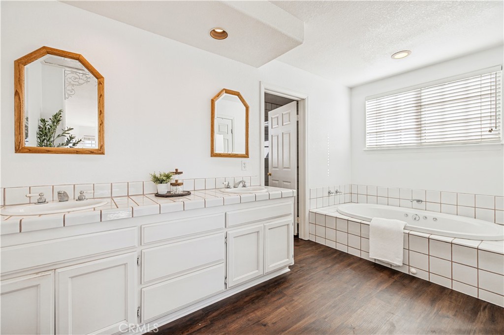 4131 Pelona Canyon Road Acton, CA 93510 - Photo 29 of 58 a bathroom with a double vanity sink mirror and bathtub