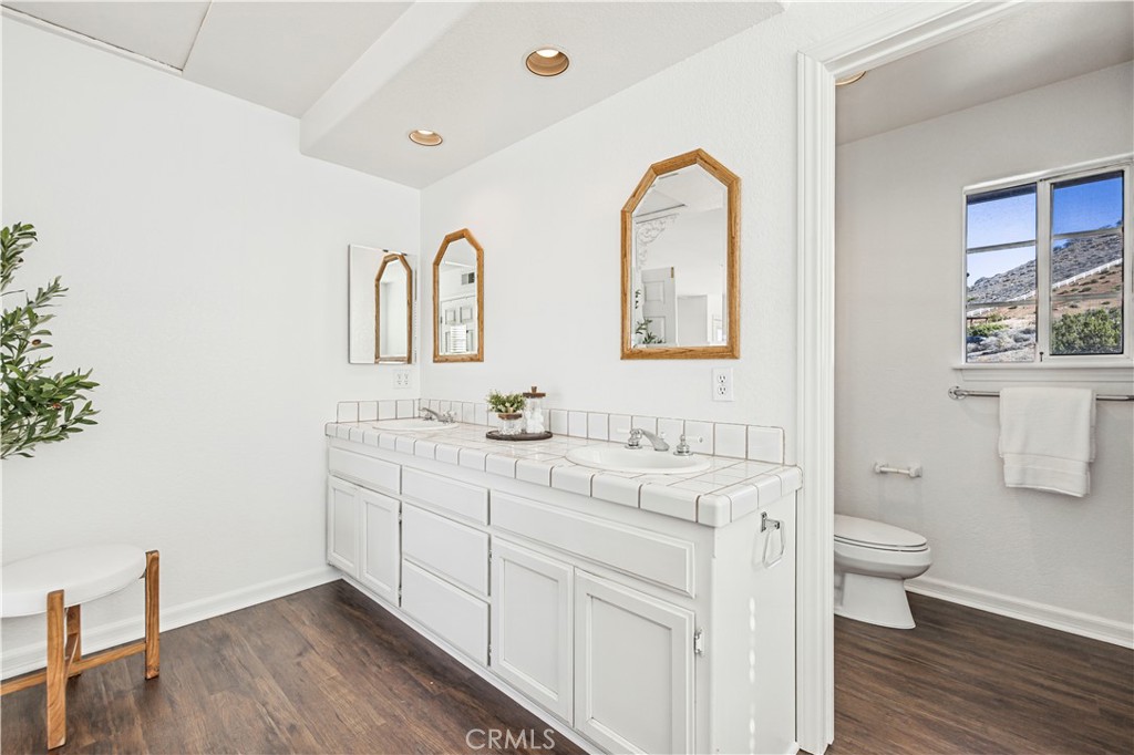 4131 Pelona Canyon Road Acton, CA 93510 - Photo 30 of 58 a spacious bathroom with 2 sink toilet and a mirror