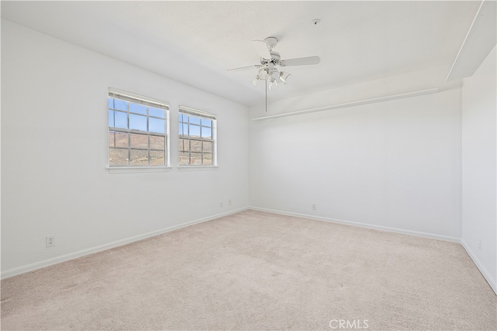 4131 Pelona Canyon Road Acton, CA 93510 - Photo 34 of 58 an empty room with windows and chandelier fan