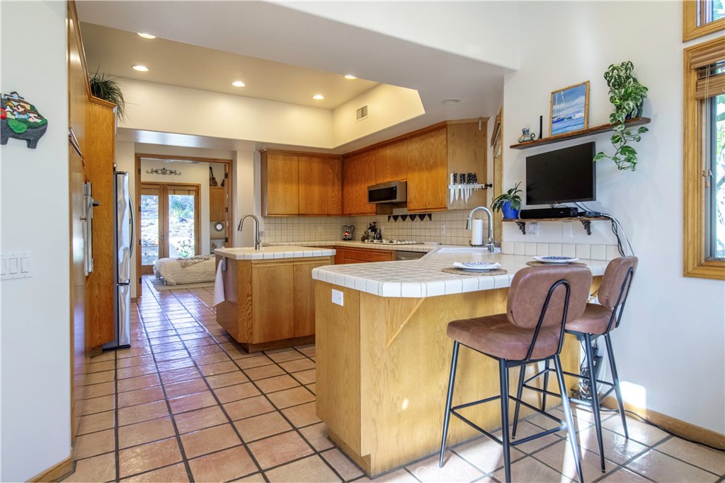 10900 Rimpau Road Fallbrook, CA 92028 - Photo 4 of 14 a kitchen with a sink and a refrigerator