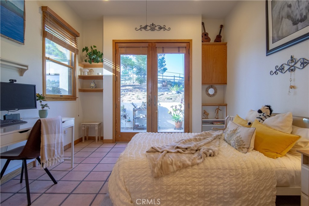 10900 Rimpau Road Fallbrook, CA 92028 - Photo 8 of 14 a bedroom with a bed and a window