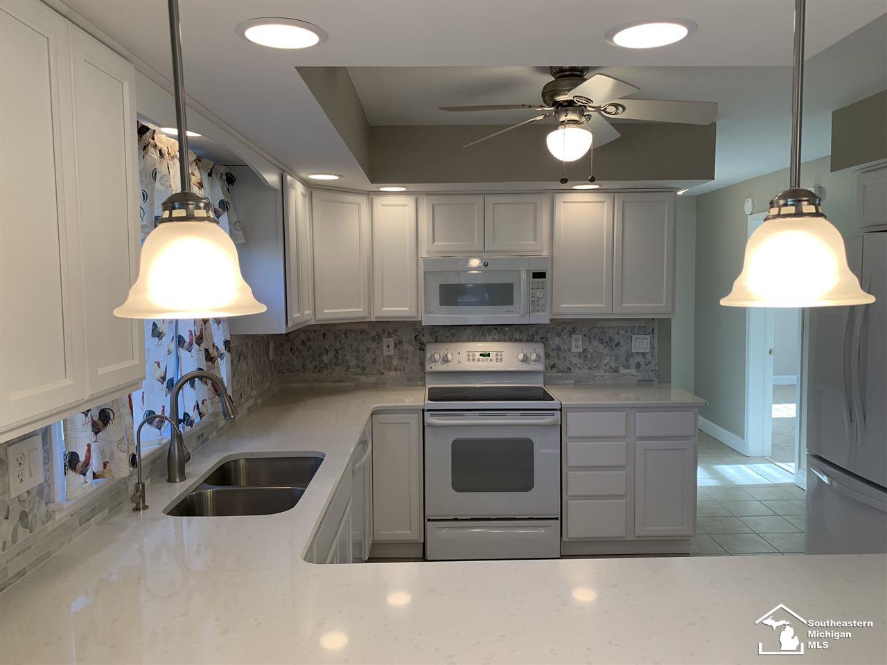 10412 Bacon Road Petersburg, MI 49270 - Photo 15 of 95 Beautiful new kitchen featuring Thomasville Cabinetry, quartz countertops, ceramic tile and new appliances.