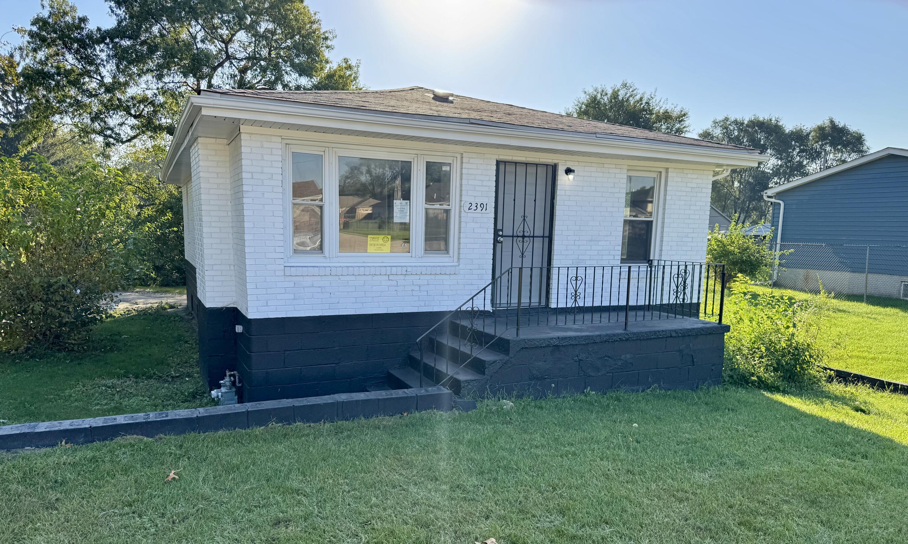 a view of house with backyard and garden