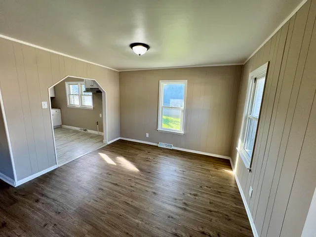 a view of a room with wooden floor and cabinet