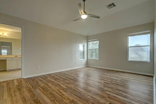 wooden floor in an empty room with a window