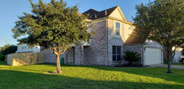 a front view of house with a garden