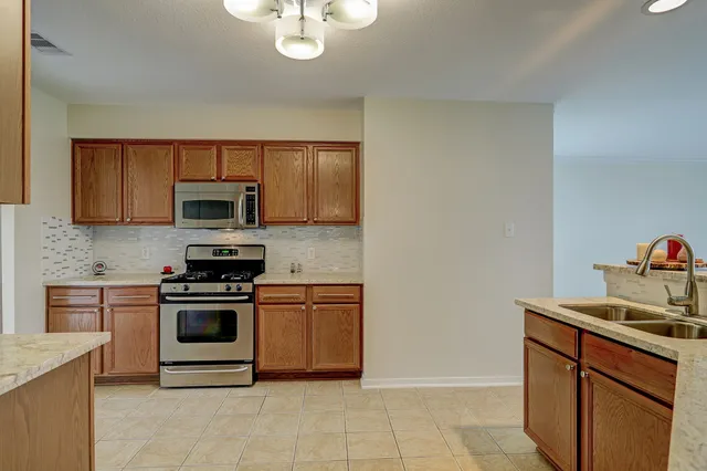 a kitchen with stainless steel appliances granite countertop a sink and cabinets