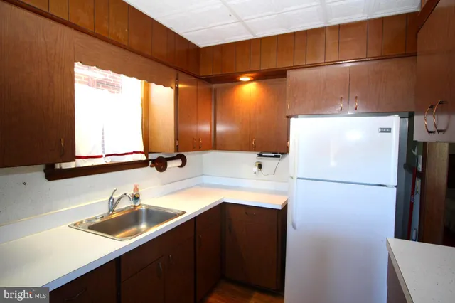 a kitchen with a sink a refrigerator and a sink