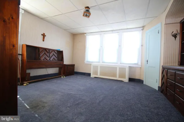 a view of a room with furniture and windows