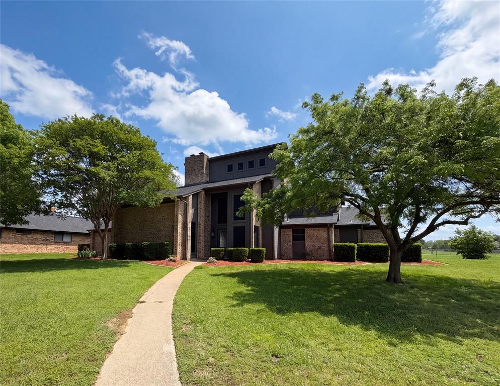 404 Laurel Trail North Terrell, TX 75160 - Photo 2 of 29 a front view of a house with a garden and trees