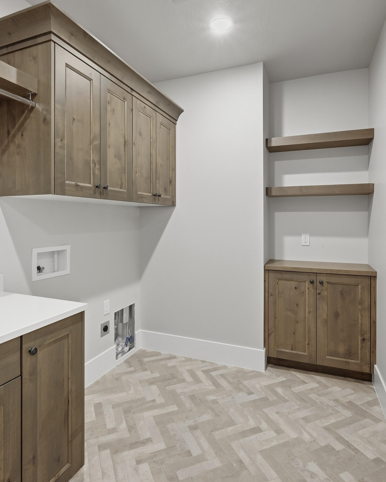1852 South Hidden Canyon Road Cedar City, UT 84720 - Photo 32 of 79 The laundry room features upper and lower cabinets, a sink, and open shelving for additional storage.