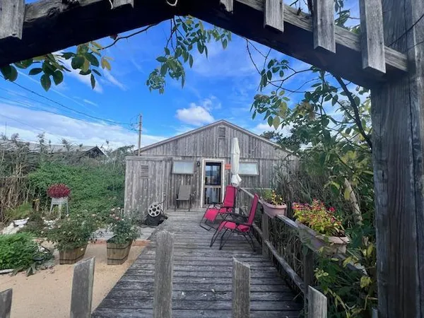 a view of a house with a flower garden