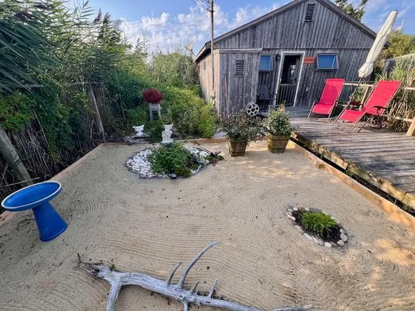 a view of a road with potted plants