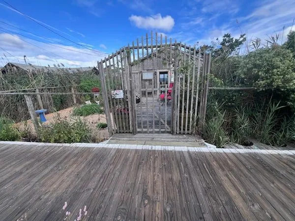 a view of a pathway with a wrought fence