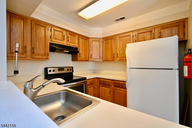 4 Cedar Court Bedminster, NJ 07921 - Photo 5 of 16 a kitchen with stainless steel appliances granite countertop a refrigerator and a sink