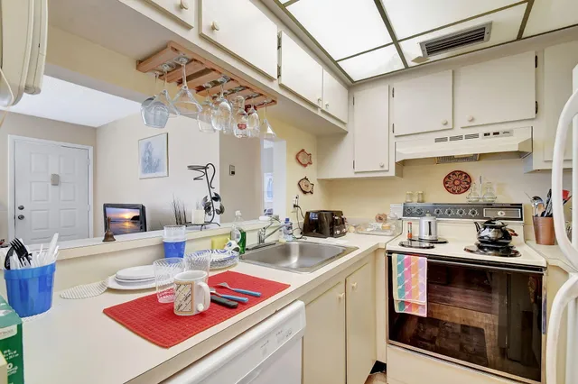 a kitchen with stainless steel appliances granite countertop a sink a stove and cabinets