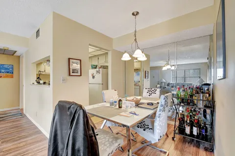 a kitchen with a sink dishwasher and cabinets with wooden floor