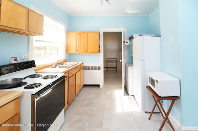 a kitchen with a stove a refrigerator and a dining table