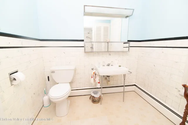 a bathroom with a toilet sink and shower