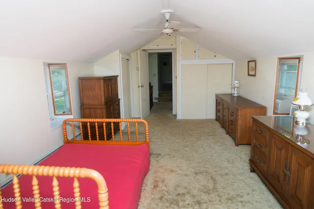 a bedroom with furniture and a window