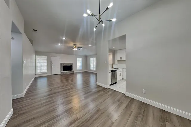 wooden floor in an empty room with a kitchen