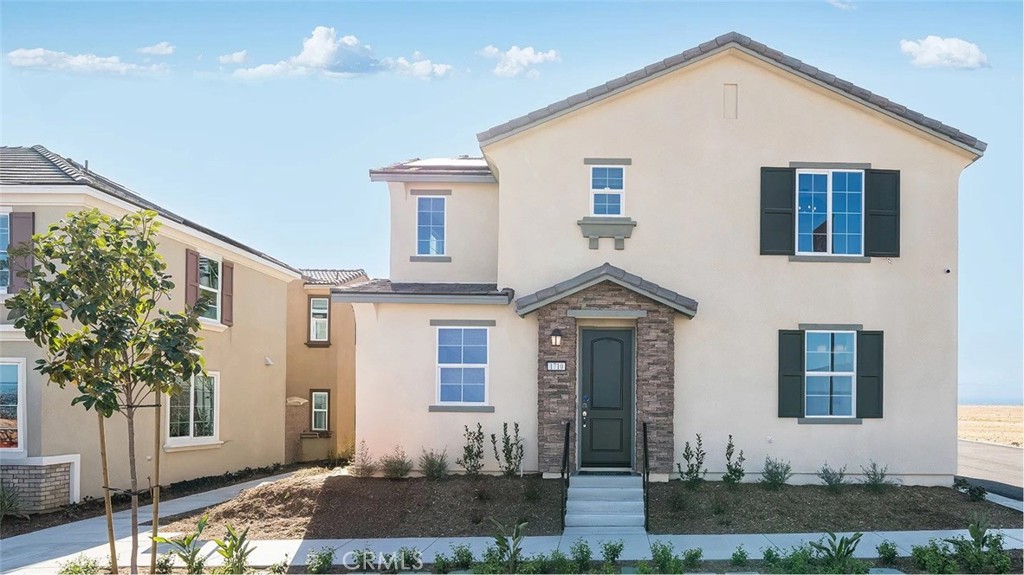 1279 Galaxy Way Rialto, CA 92376 - Photo 17 of 24 a front view of a house with a yard