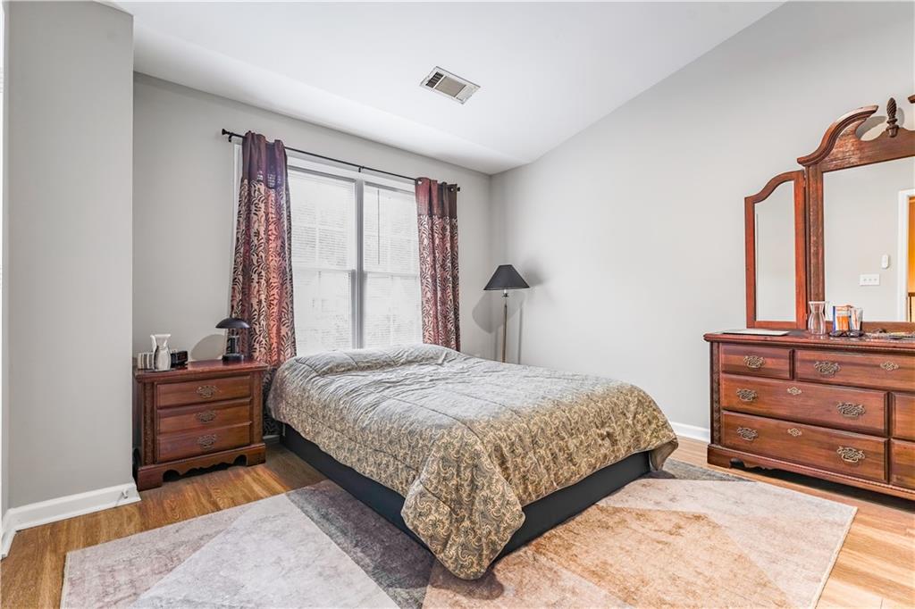 5331 Sherwin Drive Norcross, GA 30093 - Photo 16 of 29 a bedroom with a bed and a dresser