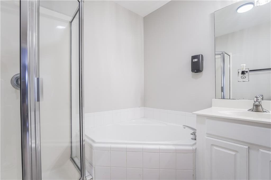 5331 Sherwin Drive Norcross, GA 30093 - Photo 19 of 29 a bathroom with a sink a toilet and a mirror