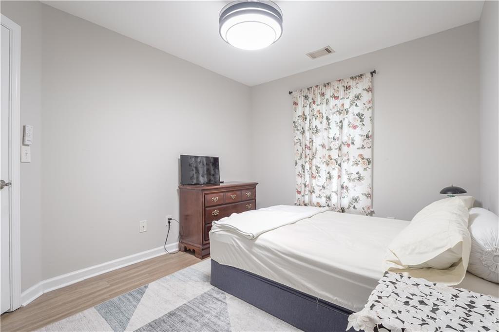 5331 Sherwin Drive Norcross, GA 30093 - Photo 29 of 29 a bedroom with a bed and a lamp with window