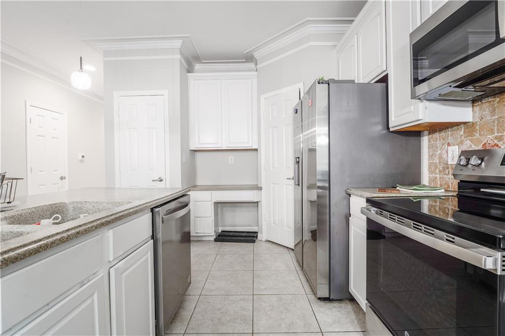 5331 Sherwin Drive Norcross, GA 30093 - Photo 8 of 29 a kitchen with stainless steel appliances granite countertop a refrigerator and a stove