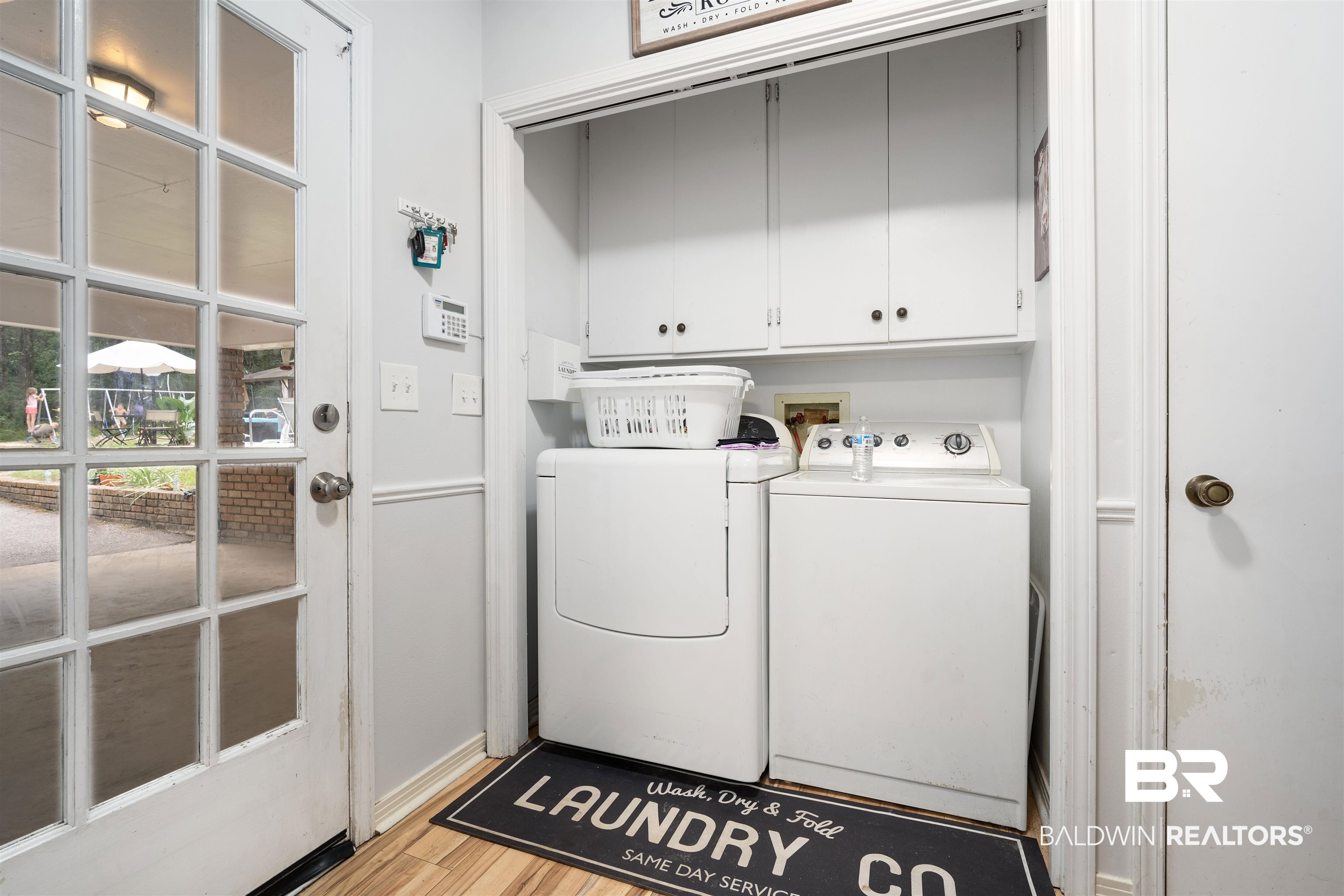 7807 Yorkhaven Road Mobile, AL 36695 - Photo 27 of 34 Washroom featuring cabinet space, independent washer and dryer, and light wood-type flooring