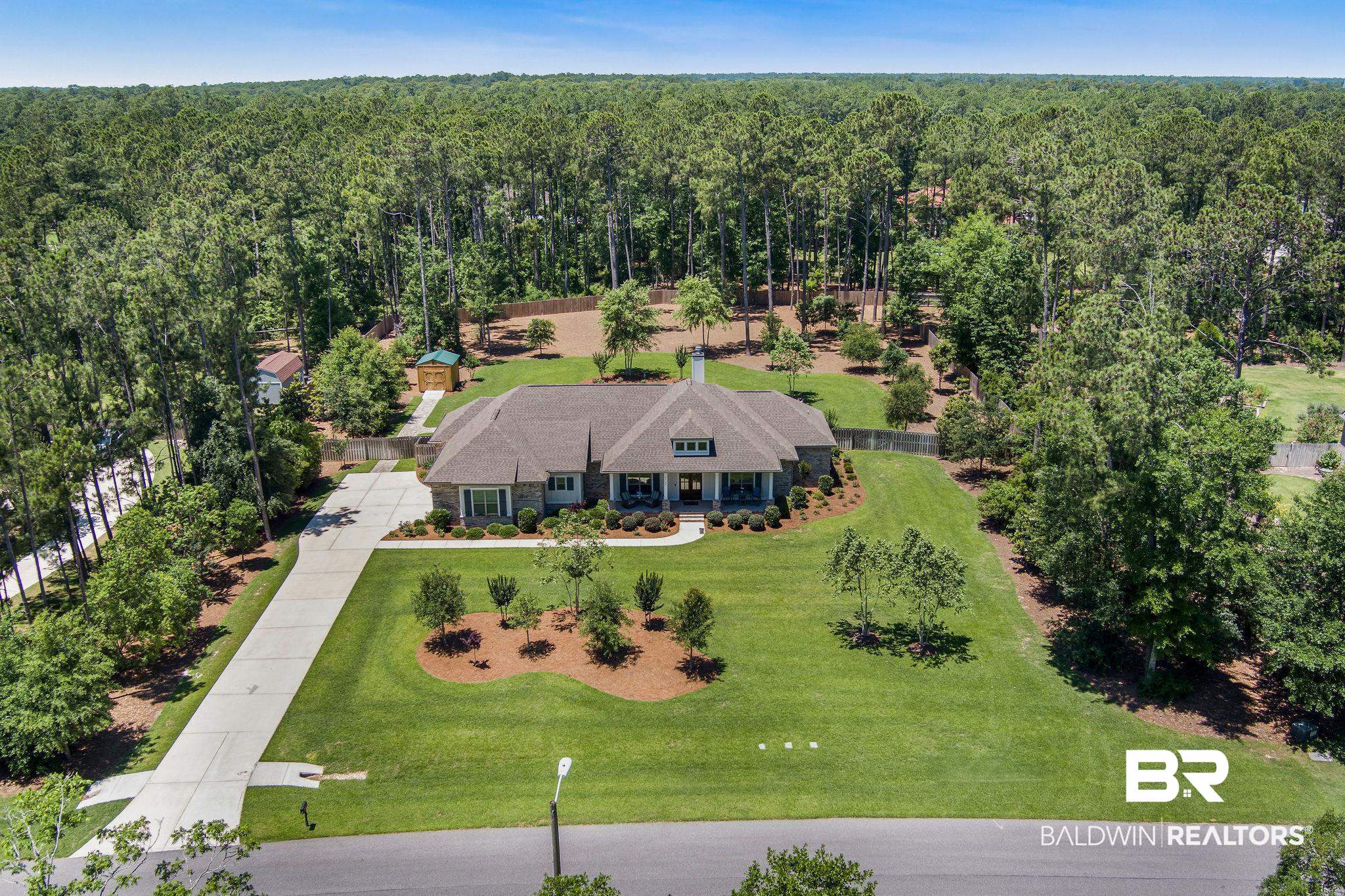 5169 Beatrice Road Gulf Shores, AL 36542 - Photo 3 of 62 View of subject property with a forest