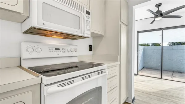 a kitchen with appliances cabinets and a table