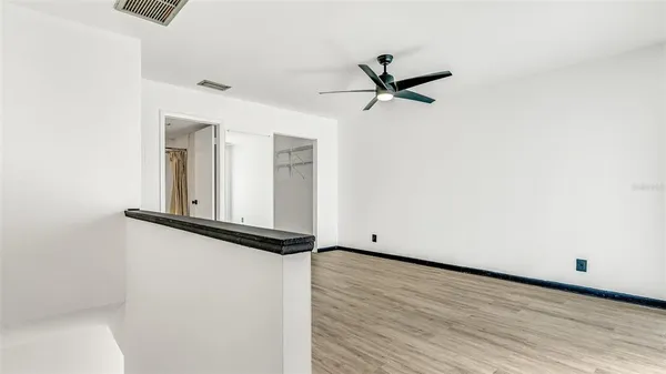 a view of a hallway with wooden floor