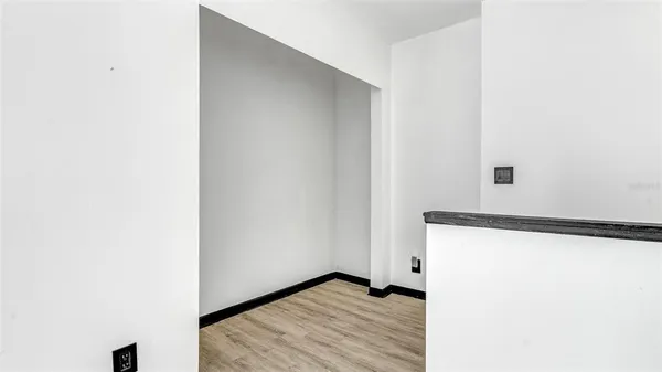 a view of a hallway with wooden floor