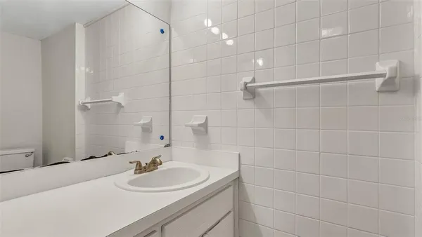 a bathroom with a sink shower and a mirror